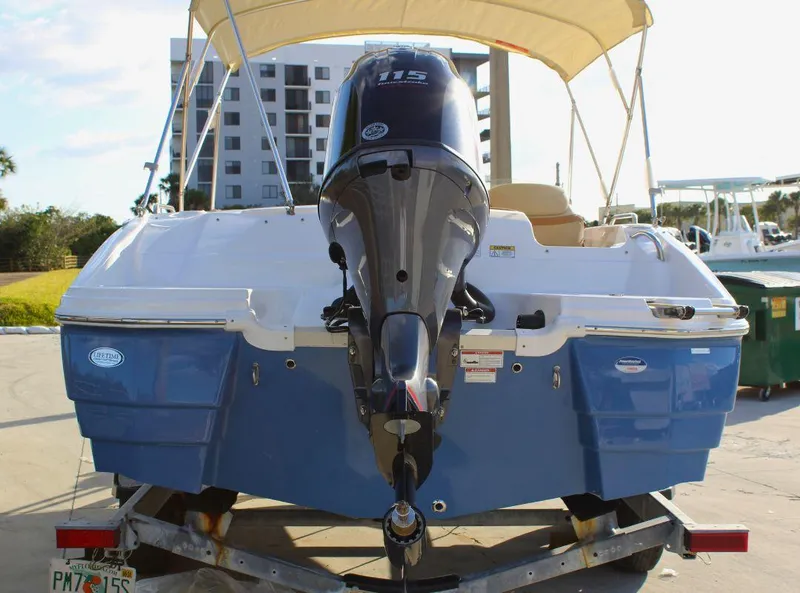 Slide: The Image of 2024 NauticStar 193 SC boat with Yamaha 115 engine, docked under a canopy. - 4