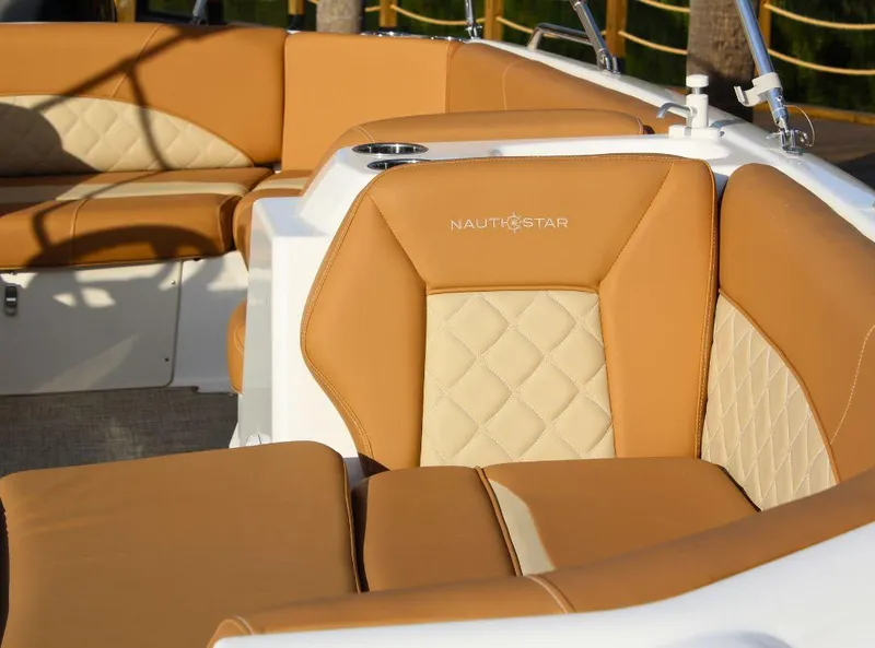 Slide: The Image of 2024 NauticStar 193 SC boat interior with tan and cream seating. - 5