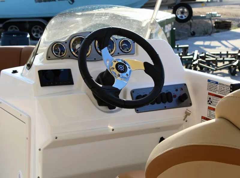 Slide: The Image of 2024 NauticStar 193 SC boat dashboard with steering wheel and instrument panel. - 8