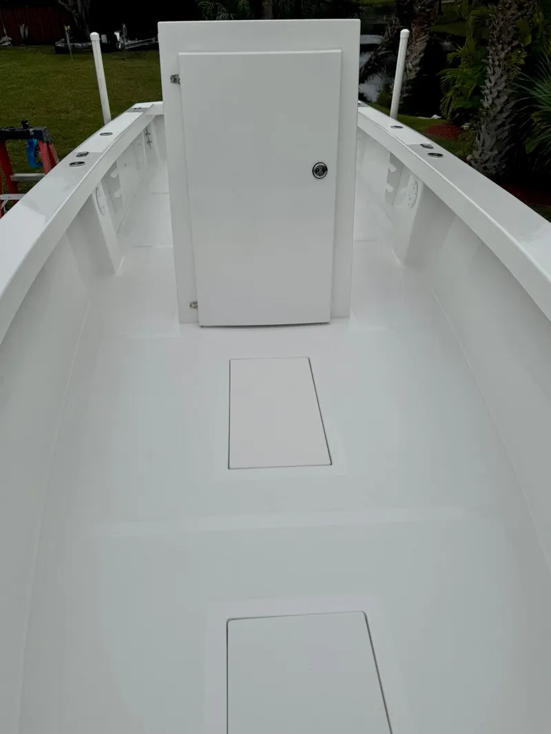 Slide: The Image of 2025 Rambo 27 boat deck with storage compartments and a central door. - 11