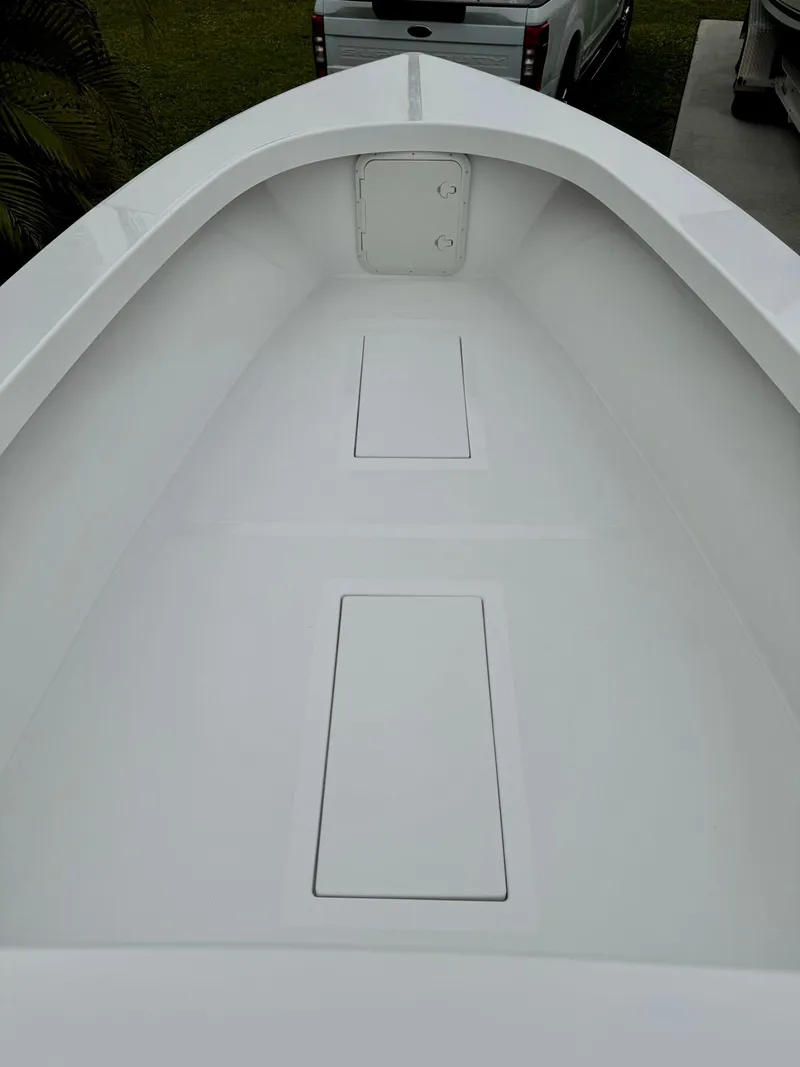 Slide: The Image of 2025 Rambo 27 boat interior with sleek white deck and storage compartments. - 12