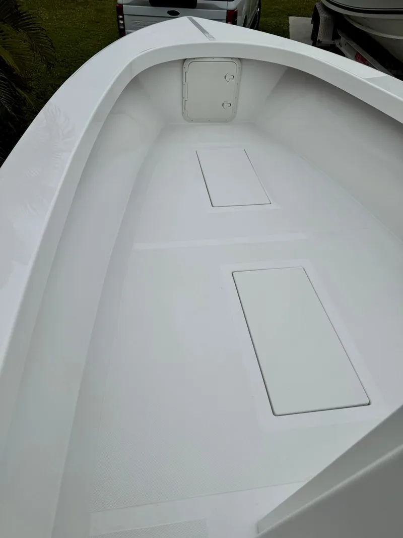 Slide: The Image of 2025 Rambo 27 boat interior, featuring a sleek white deck with storage compartments. - 13