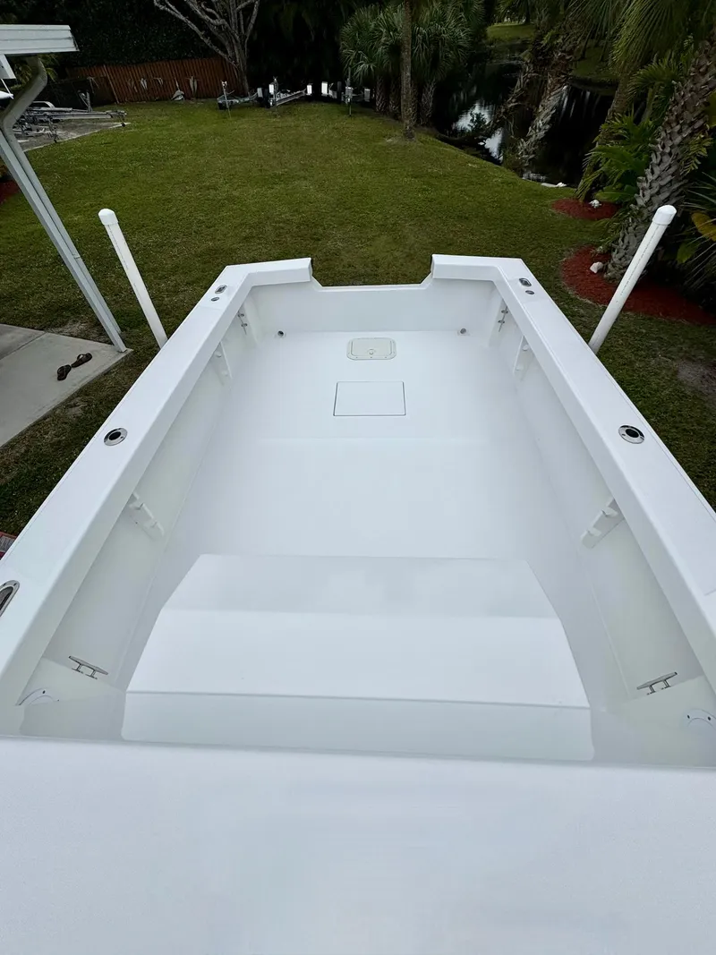 Slide: The Image of 2025 Rambo 27 boat interior, white deck, spacious layout, outdoor setting. - 18