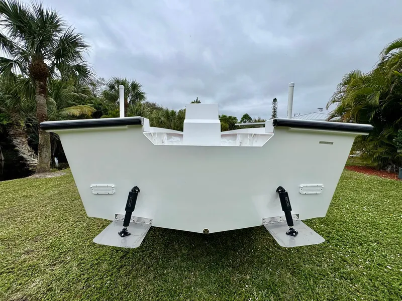 Slide: The Image of Rambo 27 boat, 2025 model, rear view on grass with palm trees in background. - 4