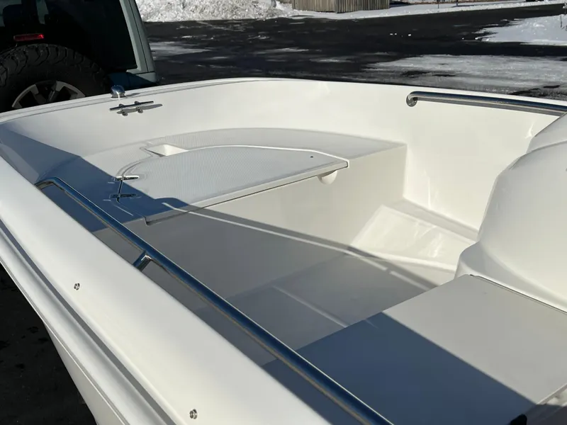 Slide: The Image of 2016 Boston Whaler 150 Super Sport boat interior, showcasing sleek white design. - 11