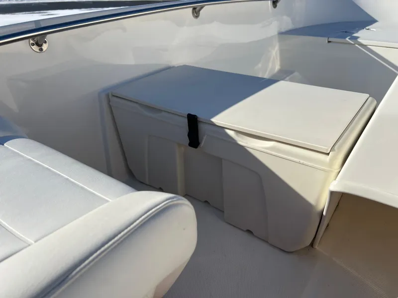 Slide: The Image of 2016 Boston Whaler 150 Super Sport interior seating and storage area. - 12