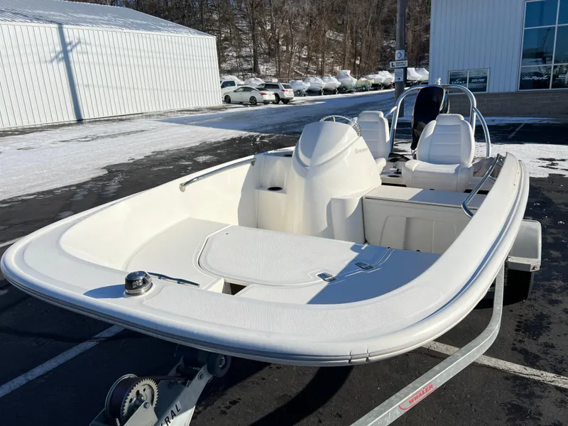 Slide: The Image of 2016 Boston Whaler 150 Super Sport boat on trailer in snowy parking lot. - 2