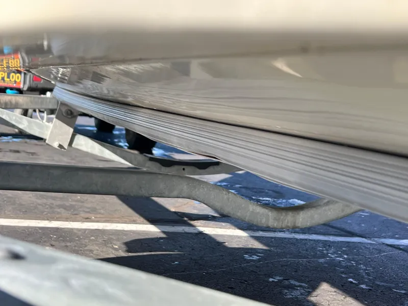 Slide: The Image of 2016 Boston Whaler 150 Super Sport on trailer, close-up view of hull and support. - 6