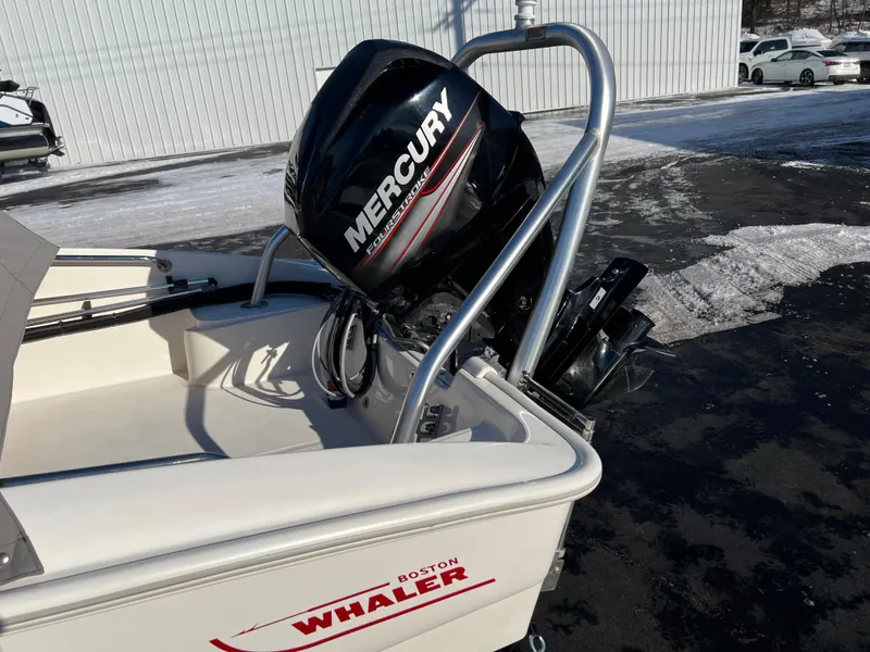 Slide: The Image of 2016 Boston Whaler 150 Super Sport with Mercury engine, parked on snowy pavement. - 9
