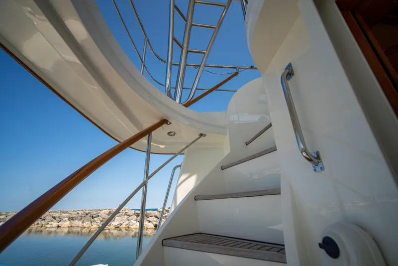 Slide: The Image of Staircase on 2004 Grand Banks 58 Eastbay FB yacht, with clear blue sky background. - 13
