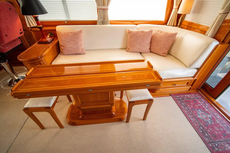 Slide: The Image of Luxurious interior of 2004 Grand Banks 58 Eastbay FB with elegant wood table and plush seating. - 17