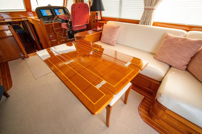 Slide: The Image of Luxurious interior of 2004 Grand Banks 58 Eastbay FB yacht with polished wood table. - 19