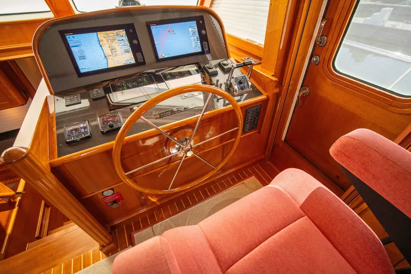 Slide: The Image of Helm of 2004 Grand Banks 58 Eastbay FB with navigation screens and wooden steering wheel. - 28