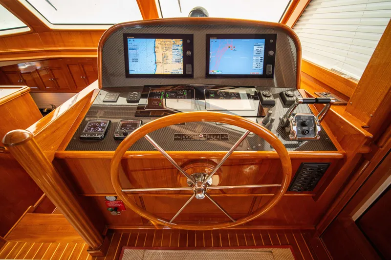 Slide: The Image of Helm of 2004 Grand Banks 58 Eastbay FB with dual navigation screens and wooden steering wheel. - 29