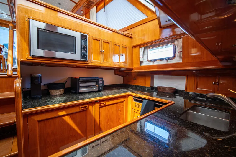 Slide: The Image of Luxurious kitchen interior of 2004 Grand Banks 58 Eastbay FB yacht with wooden cabinetry. - 37