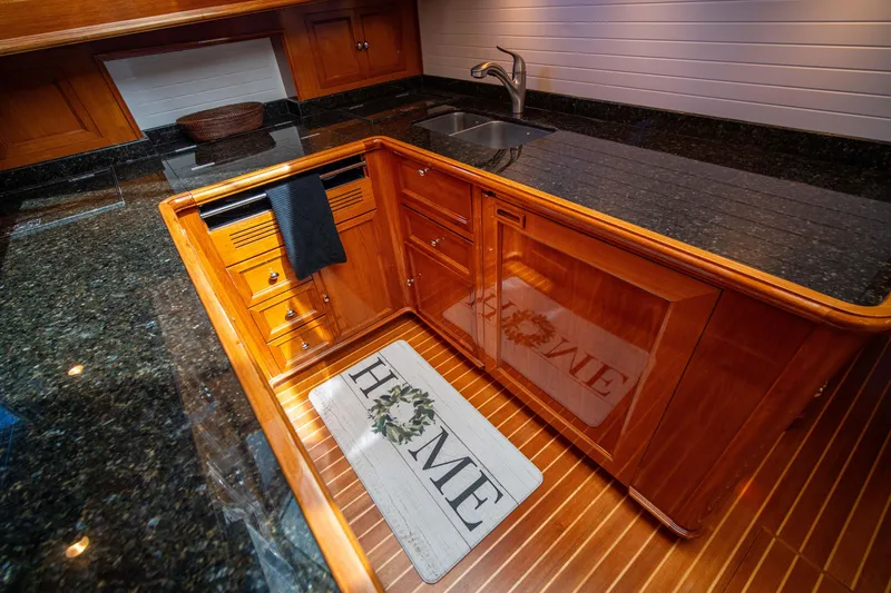 Slide: The Image of Luxurious kitchen area in a 2004 Grand Banks 58 Eastbay FB yacht, featuring wood cabinetry. - 38