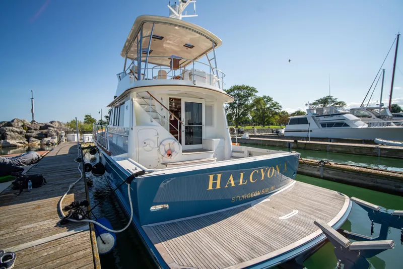 Slide: The Image of 2004 Grand Banks 58 Eastbay FB yacht docked at marina, sunny day. - 9