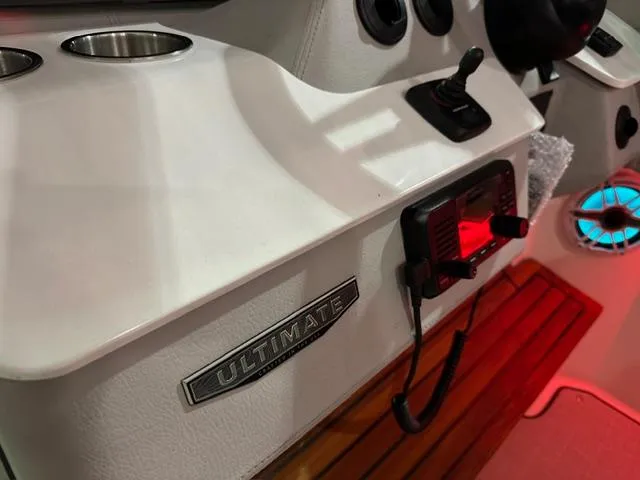 Slide: The Image of Control panel of 2025 Regal LS36 boat with cup holders and electronic equipment. - 11