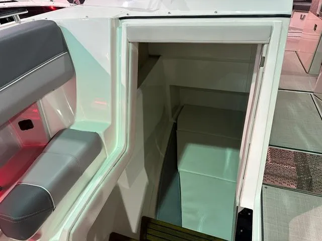 Slide: The Image of 2025 Regal LS36 boat interior with seating and cabin entrance. - 16