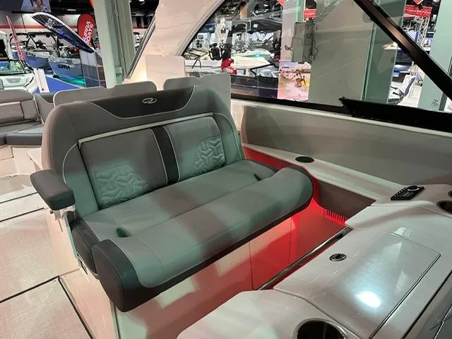 Slide: The Image of 2025 Regal LS36 boat interior with luxurious seating and ambient lighting. - 19