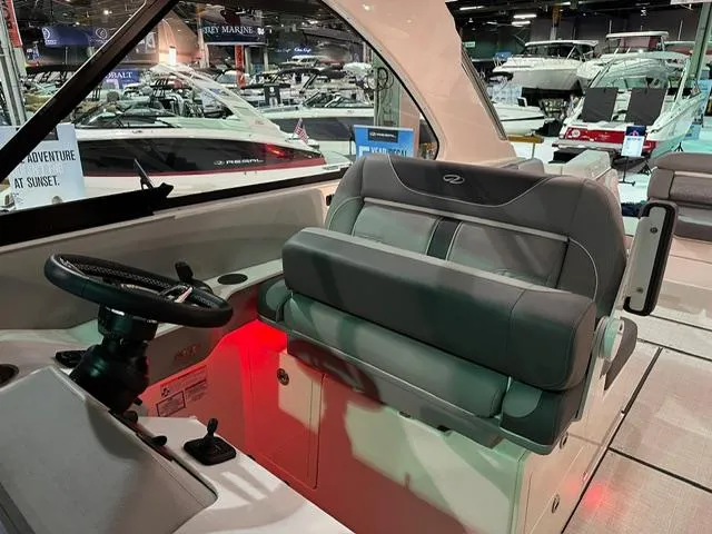 Slide: The Image of 2025 Regal LS36 boat interior with modern helm and seating at a boat show. - 20