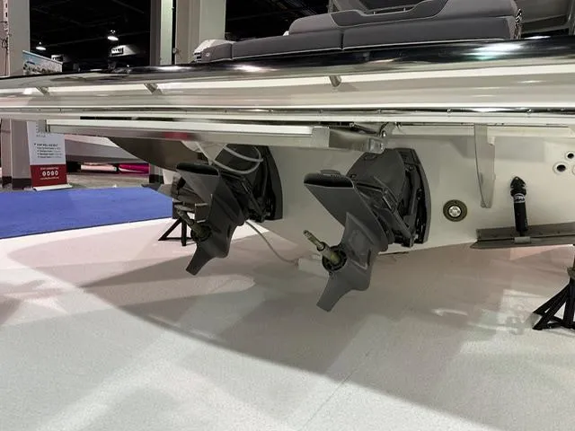 Slide: The Image of 2025 Regal LS36 boat with dual outboard motors displayed indoors. - 26
