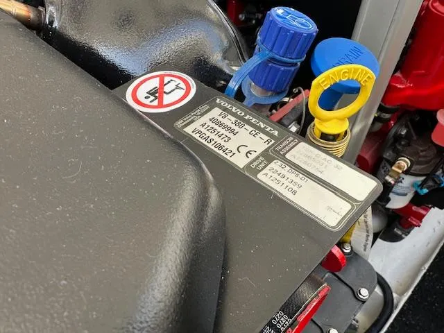 Slide: The Image of Close-up of a 2025 Regal LS36 engine with Volvo Penta components and warning labels. - 33