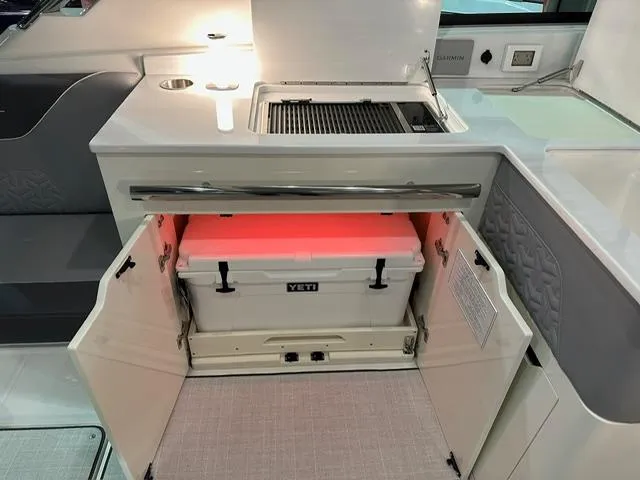Slide: The Image of 2025 Regal LS36 boat interior with Yeti cooler in storage compartment. - 7