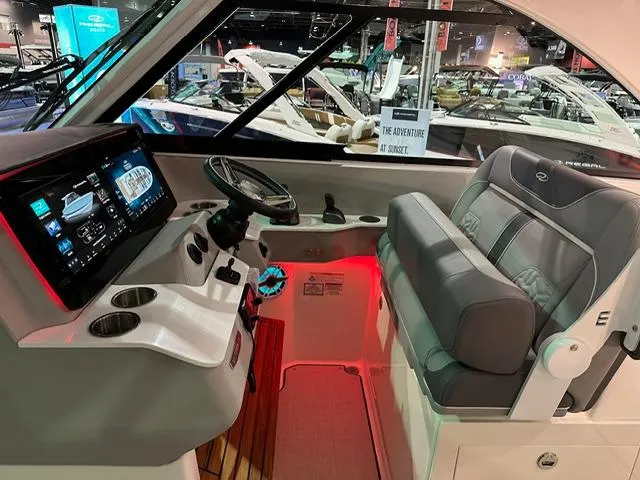 Slide: The Image of 2025 Regal LS36 boat interior with modern dashboard and seating at a boat show. - 9