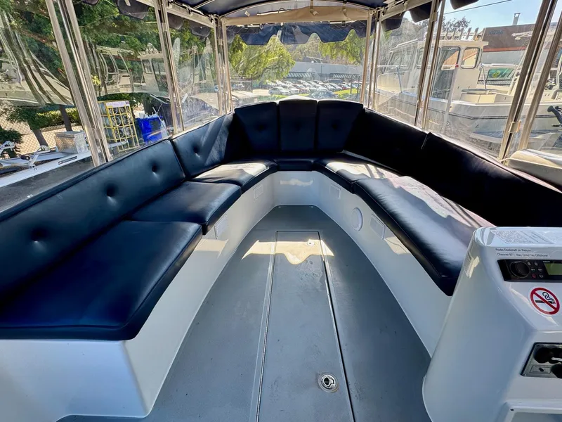 Slide: The Image of 2022 Duffy Sun Cruiser boat interior with spacious seating and clear canopy. - 16