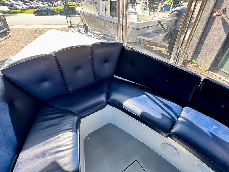 Slide: The Image of 2022 Duffy Sun Cruiser with blue cushioned seating in a sunny outdoor setting. - 19