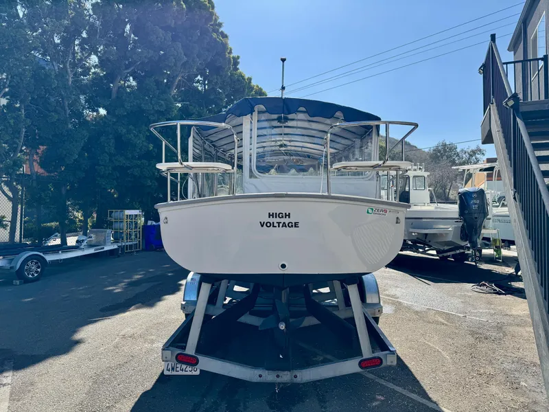 Slide: The Image of 2022 Duffy Sun Cruiser boat named "High Voltage" on a trailer in a sunny outdoor setting. - 2