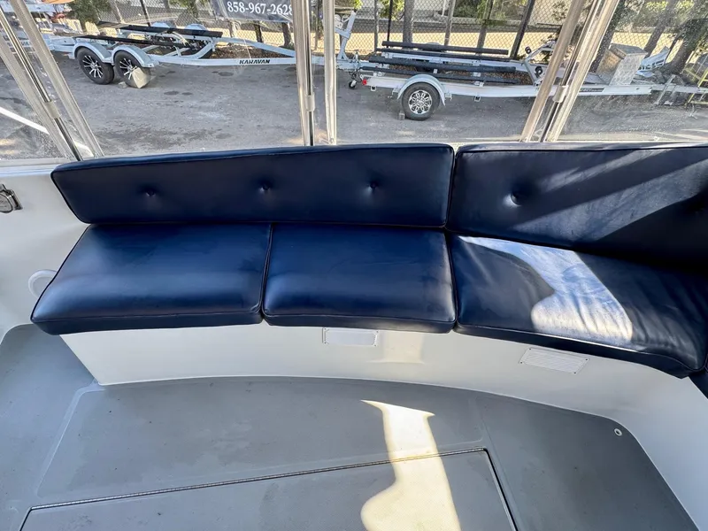 Slide: The Image of 2022 Duffy Sun Cruiser boat interior with blue cushioned seating. - 21