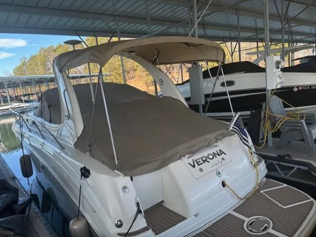 The Image of 2005 Sea Ray 300 Sundancer docked under a covered marina. - 0