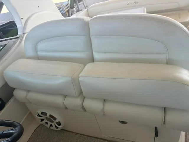 Slide: The Image of 2005 Sea Ray 300 Sundancer interior with white leather seating and speaker detail. - 12