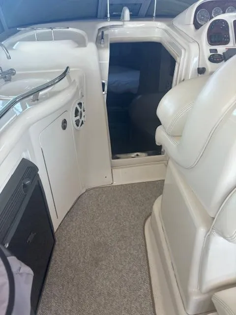 Slide: The Image of Interior view of 2005 Sea Ray 300 Sundancer boat cockpit with white seating. - 18
