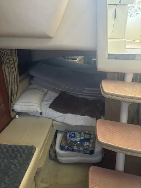 Slide: The Image of Interior cabin of 2005 Sea Ray 300 Sundancer with bedding and storage. - 22
