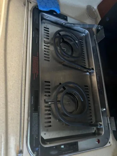 Slide: The Image of Stovetop on 2005 Sea Ray 300 Sundancer boat, featuring dual electric burners. - 24