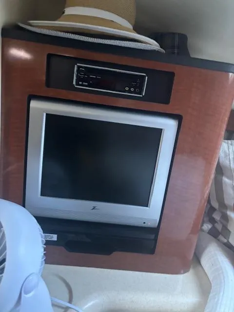 Slide: The Image of 2005 Sea Ray 300 Sundancer cabin interior with TV and fan. - 26