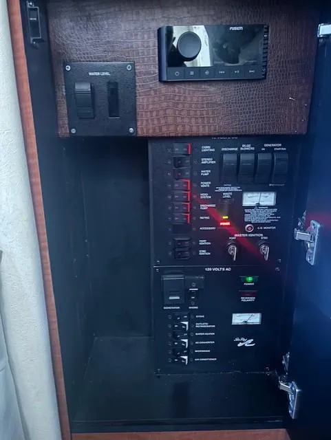 Slide: The Image of Electrical panel of a 2005 Sea Ray 300 Sundancer boat, featuring control switches and indicators. - 27