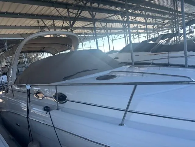 Slide: The Image of 2005 Sea Ray 300 Sundancer docked in a covered marina. - 3