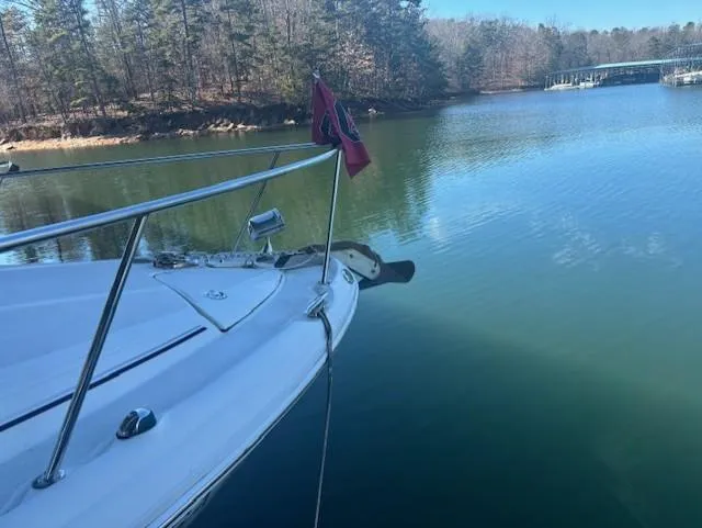 Slide: The Image of 2005 Sea Ray 300 Sundancer on a serene lake with forested shoreline. - 4