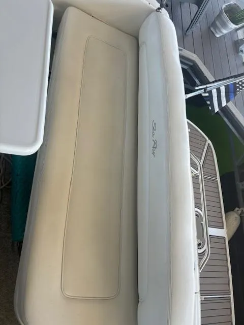 Slide: The Image of 2005 Sea Ray 300 Sundancer boat interior with white seating and deck view. - 8