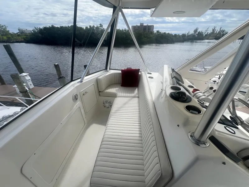 Slide: The Image of 1996 Ocean Yachts 48 Super Sport boat interior with white seating and river view. - 12