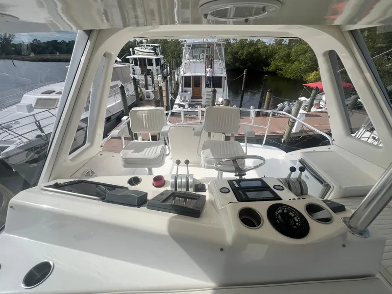 Slide: The Image of 1996 Ocean Yachts 48 Super Sport cockpit with steering wheel and control panel. - 13