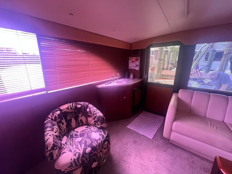 Slide: The Image of Interior of 1996 Ocean Yachts 48 Super Sport with plush seating and floral chair. - 17