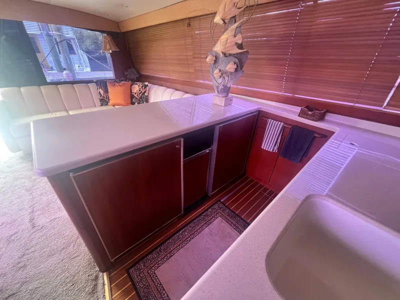 Slide: The Image of Interior of 1996 Ocean Yachts 48 Super Sport with modern kitchen and seating area. - 19
