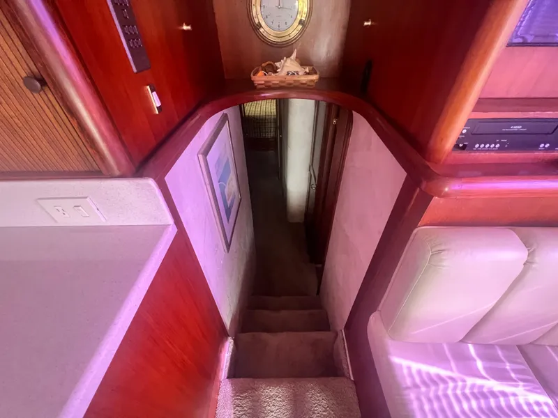 Slide: The Image of Interior view of 1996 Ocean Yachts 48 Super Sport, featuring wooden cabinetry and carpeted stairs. - 21