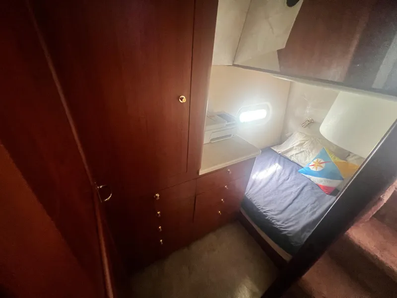 Slide: The Image of Interior cabin of 1996 Ocean Yachts 48 Super Sport with wooden cabinetry and cozy bed. - 22