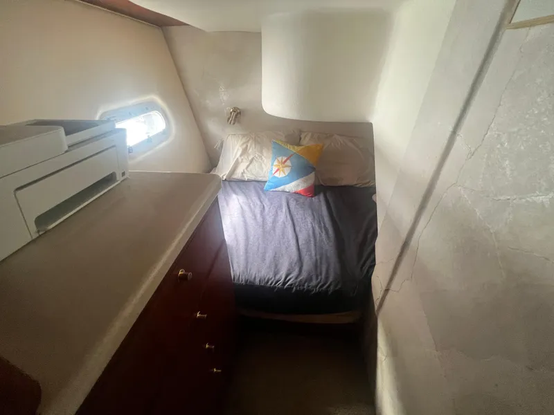 Slide: The Image of 1996 Ocean Yachts 48 Super Sport cabin with bed, window, and storage drawers. - 23